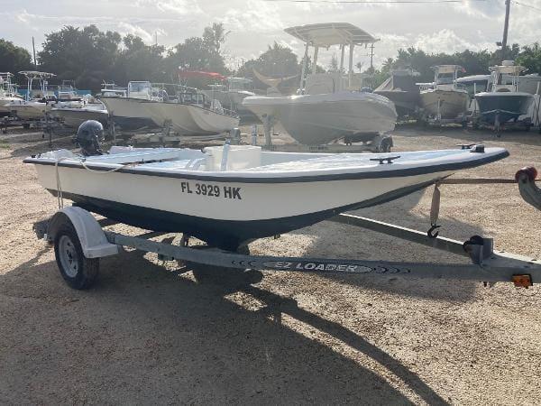 Slide: The Image of 1997 Carolina Skiff 16 DLX boat on trailer in a marina. - 3