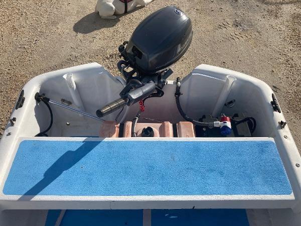Slide: The Image of 1997 Carolina Skiff 16 DLX boat with outboard motor and blue deck. - 5