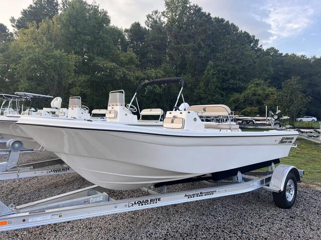 Slide: The Image of 2024 Carolina Skiff 178 JLS boat on a Load Rite trailer in a wooded area. - 2