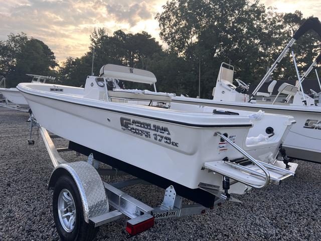 Slide: The Image of 2024 Carolina Skiff 178 JLS boat on trailer, side view, outdoor setting. - 3
