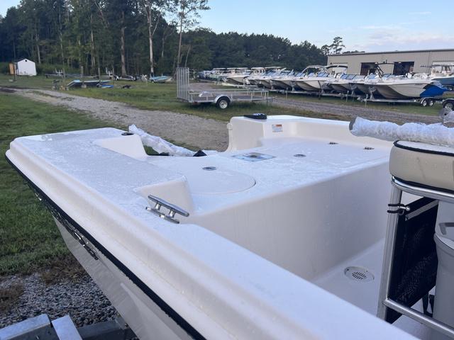 Slide: The Image of 2024 Carolina Skiff 178 JLS boat on a gravel lot with other boats. - 6