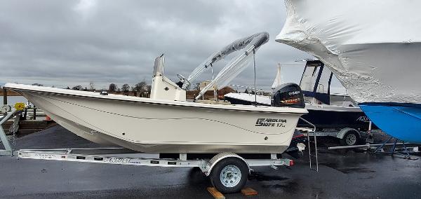 Slide: The Image of 2023 Carolina Skiff 17 LS boat on trailer, side view, overcast sky. - 3