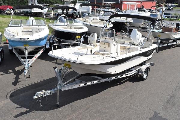 Slide: The Image of 2021 Carolina Skiff 19 LS boat on trailer, surrounded by other boats in a lot. - 2