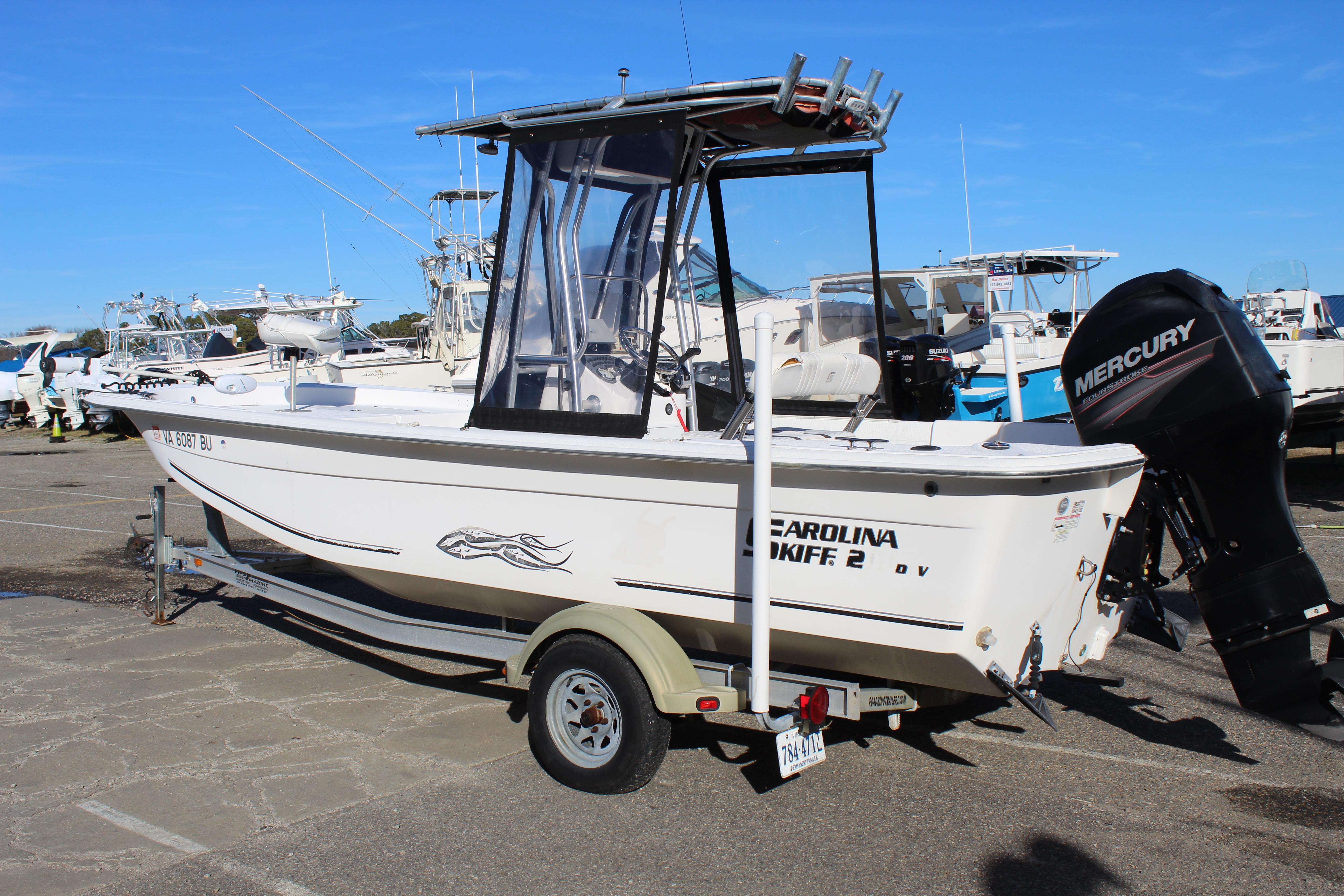 Slide: The Image of 2011 Carolina Skiff 218 DLV boat on trailer with Mercury outboard motor. - 0