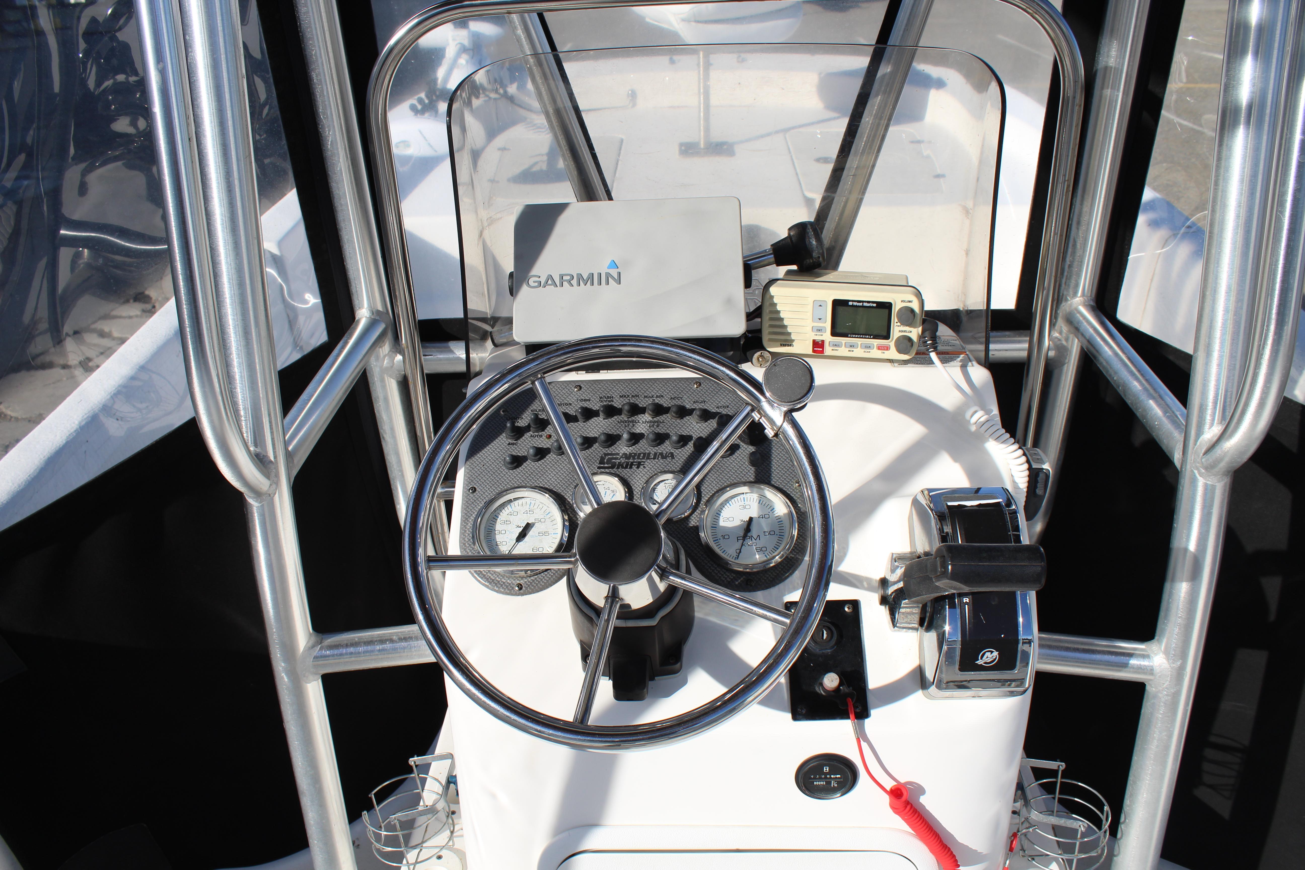 Slide: The Image of Carolina Skiff 218 DLV 2011 boat console with Garmin GPS and radio equipment. - 13