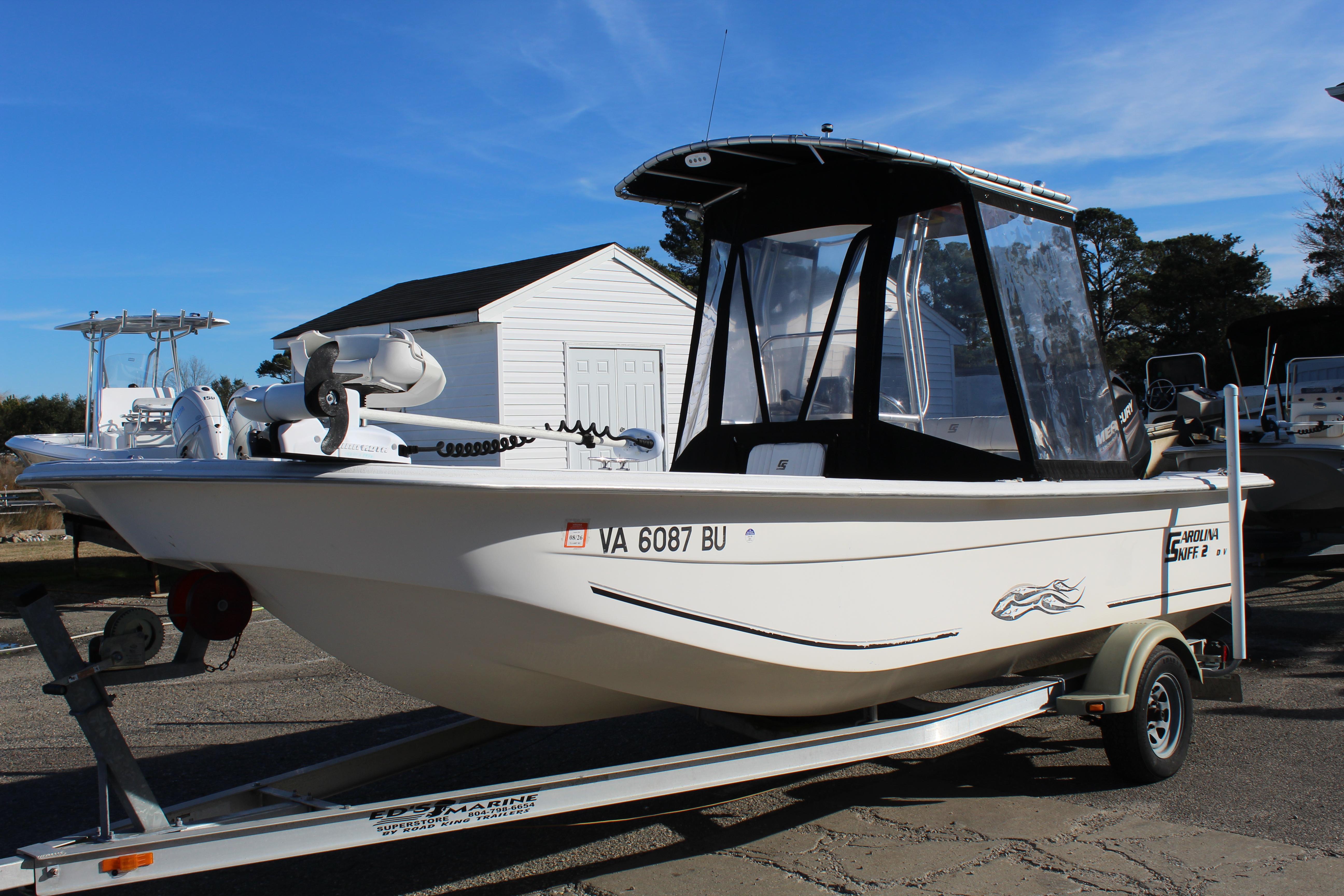 Slide: The Image of 2011 Carolina Skiff 218 DLV boat on trailer, parked outdoors. - 2