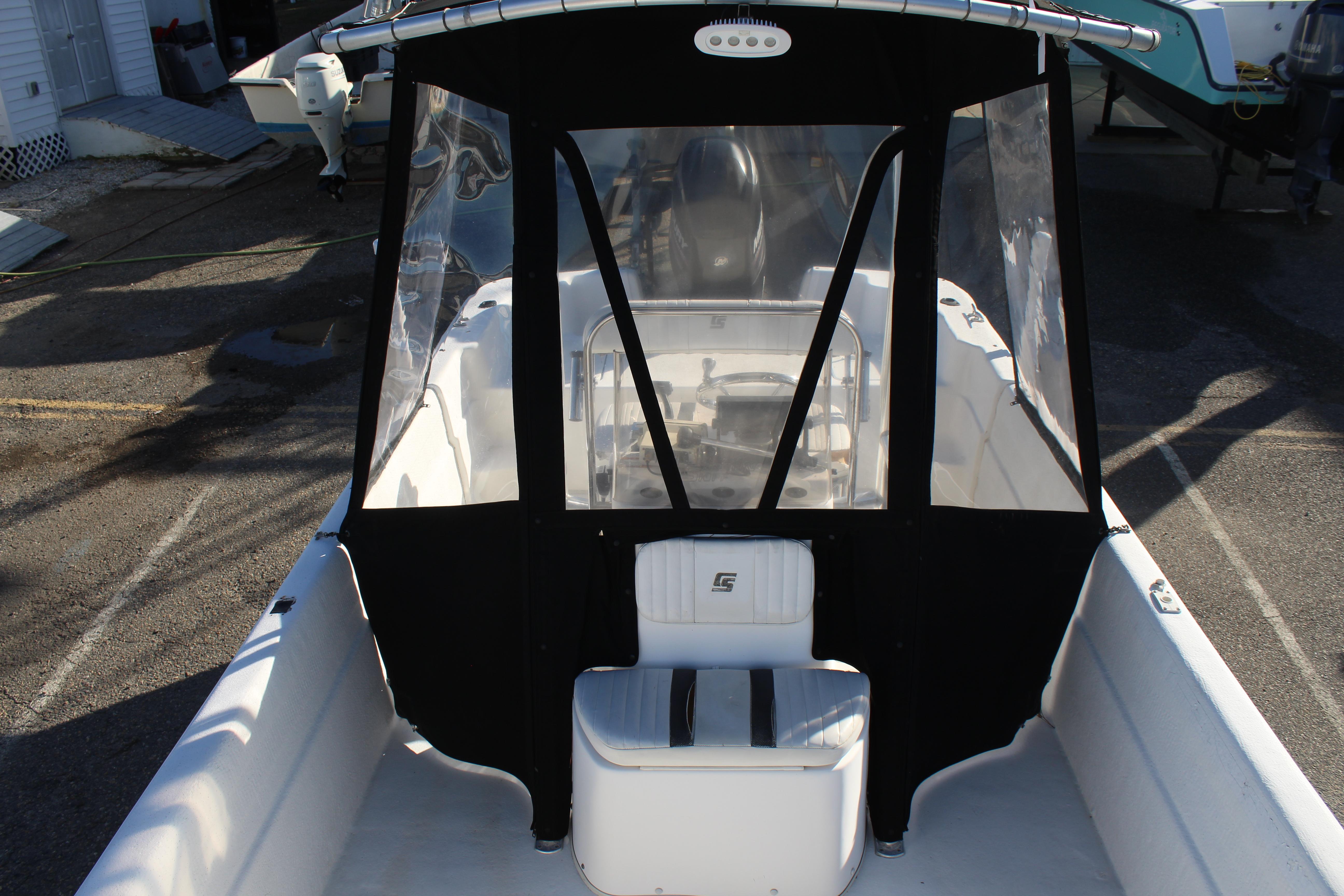 Slide: The Image of 2011 Carolina Skiff 218 DLV boat with black canopy and white interior. - 20