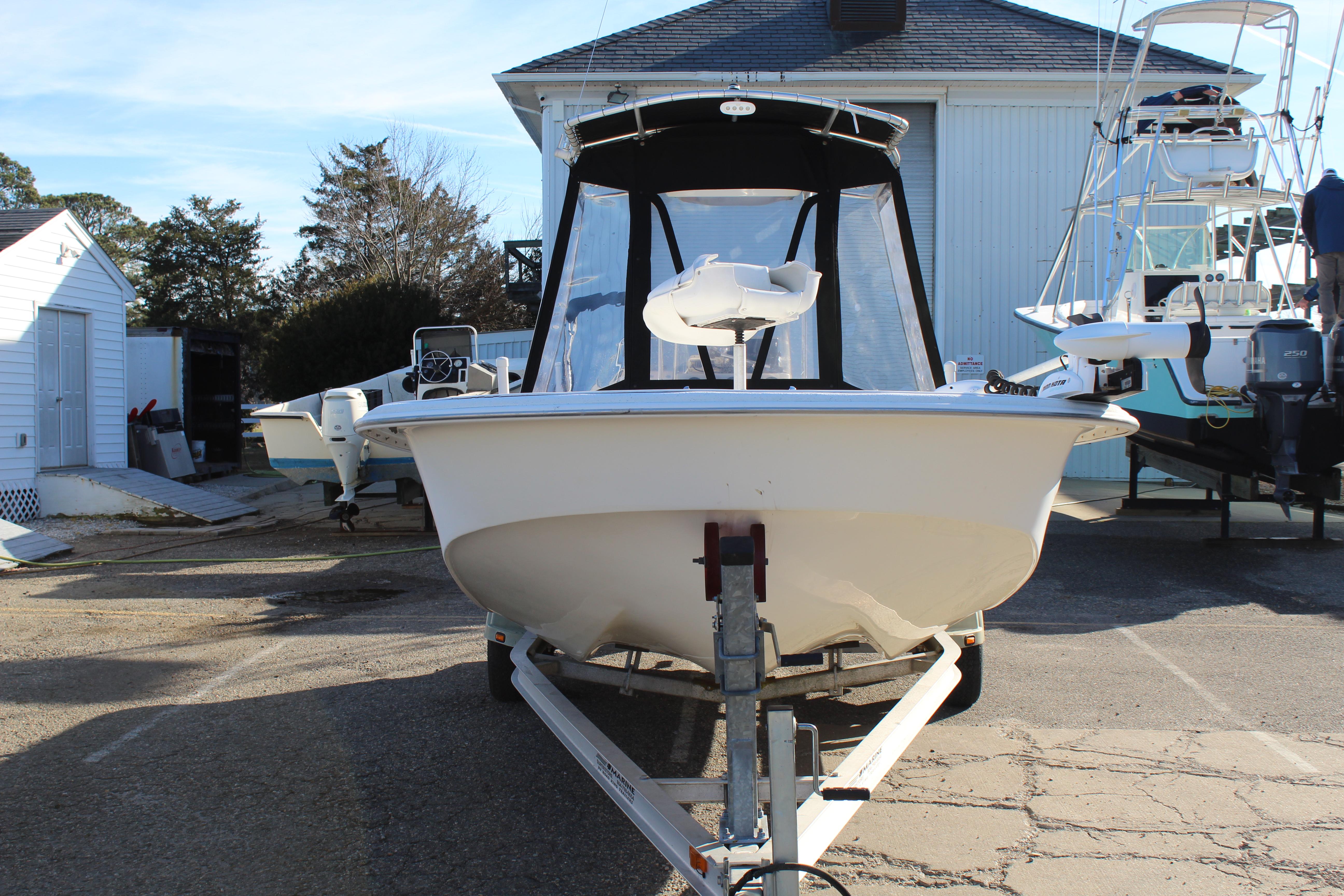 Slide: The Image of 2011 Carolina Skiff 218 DLV boat on trailer in marina setting. - 3