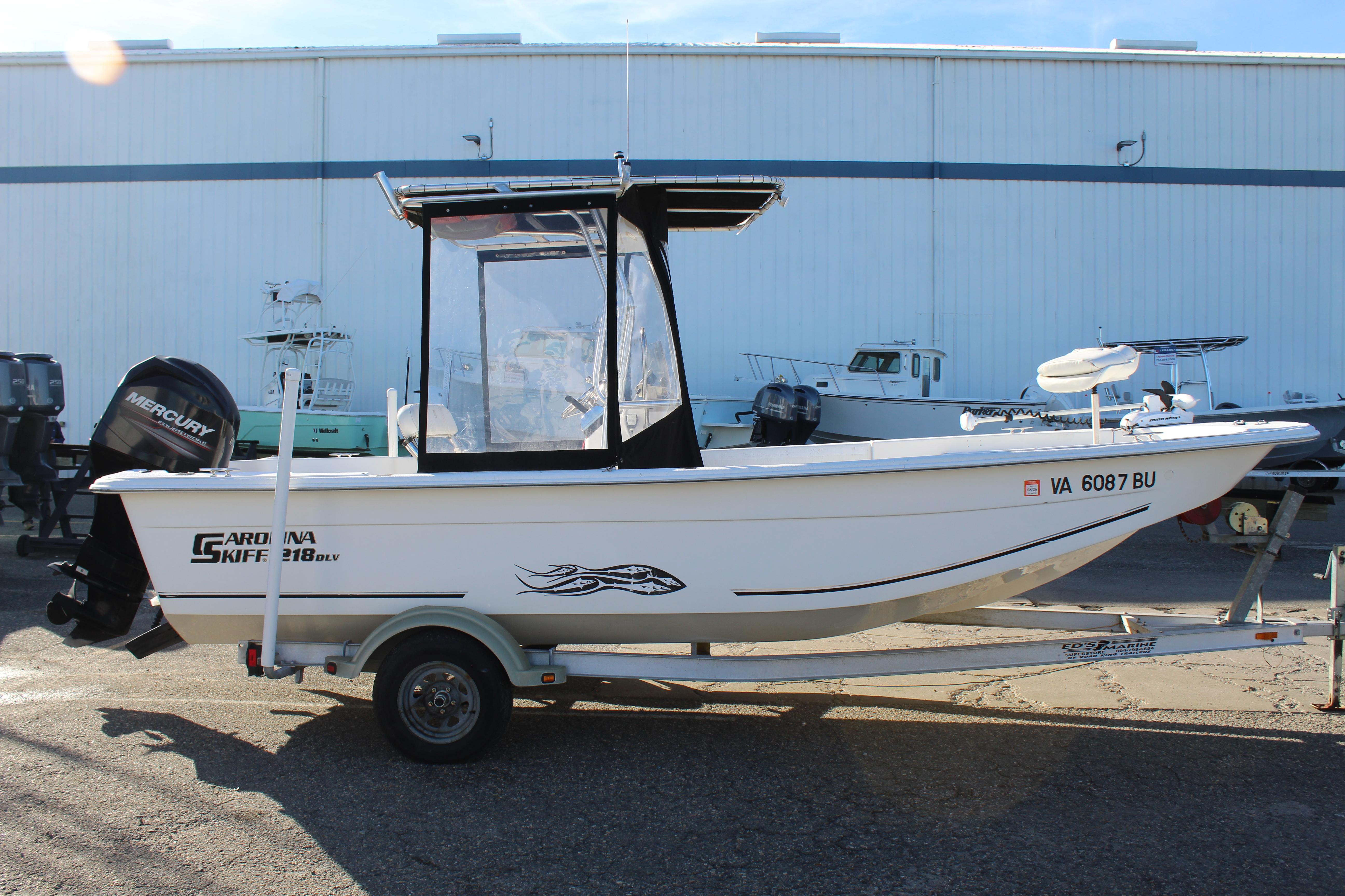 Slide: The Image of 2011 Carolina Skiff 218 DLV boat on trailer, side view, with Mercury outboard motor. - 5