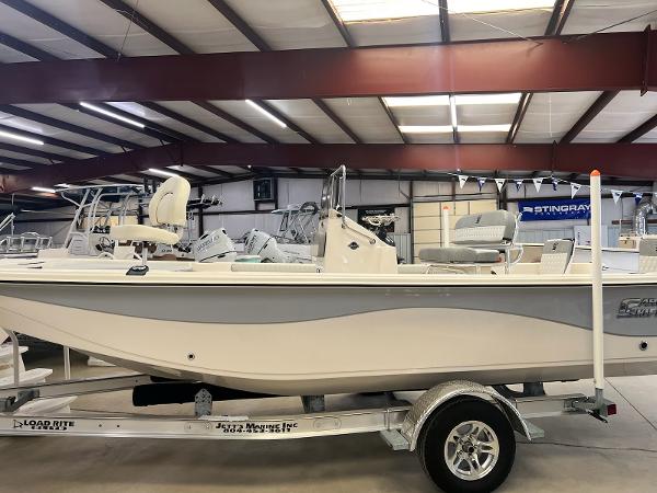 Slide: The Image of 2024 Carolina Skiff 21 LS boat on trailer in indoor showroom. - 1