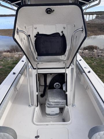 Slide: The Image of 2025 Carolina Skiff 22 Ultra Elite boat interior with storage compartment open. - 12
