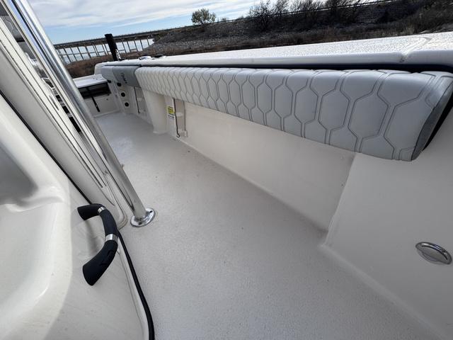 Slide: The Image of 2025 Carolina Skiff 22 Ultra Elite boat interior with cushioned seating and sleek design. - 13
