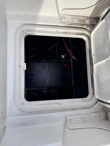 Slide: The Image of 2025 Carolina Skiff 22 Ultra Elite battery compartment with wiring visible. - 19