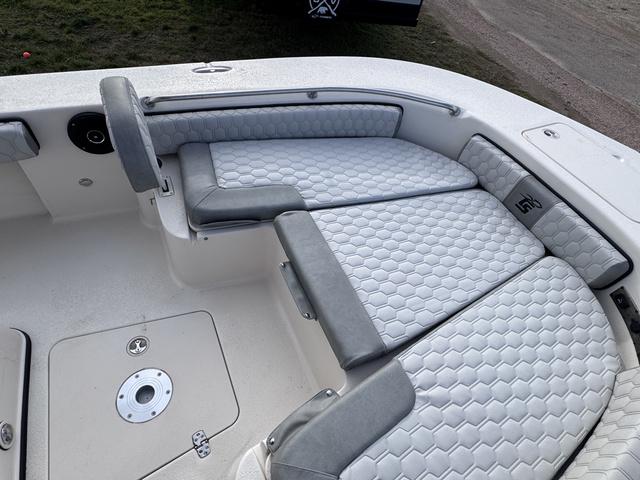 Slide: The Image of 2025 Carolina Skiff 22 Ultra Elite boat interior with cushioned seating and storage compartments. - 6