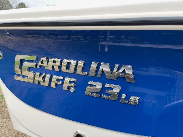 Slide: The Image of 2024 Carolina Skiff 23 LS boat model nameplate on blue hull. - 1