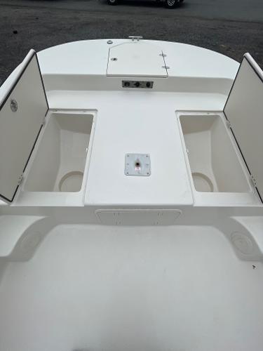 Slide: The Image of 2024 Carolina Skiff 23 LS boat with open storage compartments on deck. - 10