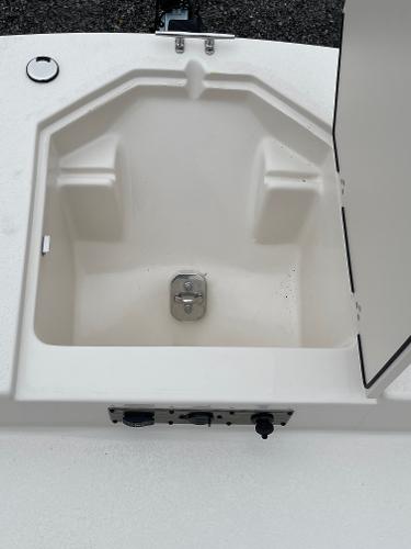 Slide: The Image of 2024 Carolina Skiff 23 LS boat storage compartment with open lid. - 12