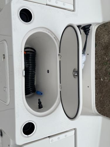 Slide: The Image of 2024 Carolina Skiff 23 LS boat storage compartment with accessories. - 14