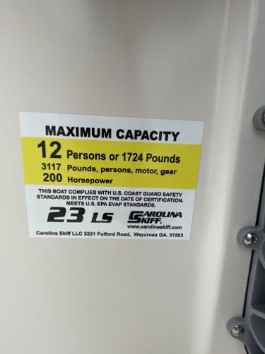 Slide: The Image of 2024 Carolina Skiff 23 LS maximum capacity label: 12 persons or 1724 pounds, 200 horsepower. - 18