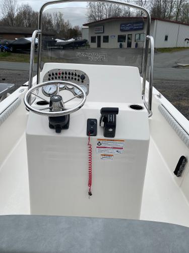 Slide: The Image of 2024 Carolina Skiff 23 LS boat console with steering wheel and controls. - 2