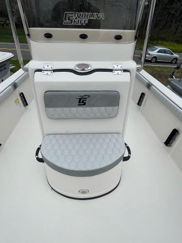 Slide: The Image of 2024 Carolina Skiff 23 LS boat interior with cushioned seating and storage. - 4
