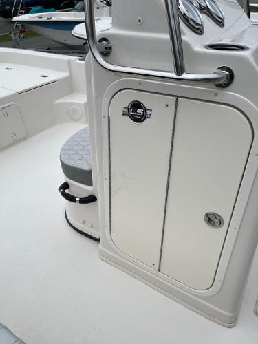 Slide: The Image of 2024 Carolina Skiff 23 LS boat interior, featuring storage compartment and seating. - 5