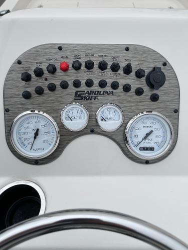 Slide: The Image of 2024 Carolina Skiff 23 LS dashboard with gauges and control panel. - 6