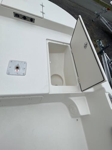 Slide: The Image of 2024 Carolina Skiff 23 LS boat with open storage compartment. - 9