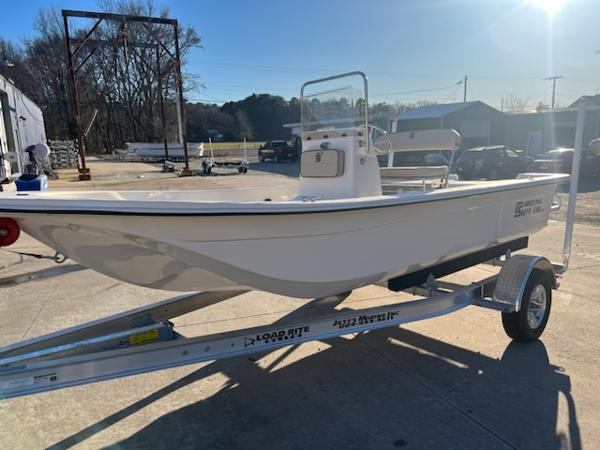 Slide: The Image of 2025 Carolina Skiff E18 CC boat on trailer in sunny outdoor setting. - 2