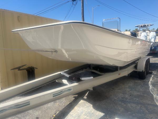 Slide: The Image of 2024 Carolina Skiff e24 DLX boat on trailer in outdoor storage. - 0