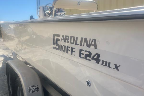 Slide: The Image of 2024 Carolina Skiff E24 DLX boat on trailer, side view. - 1