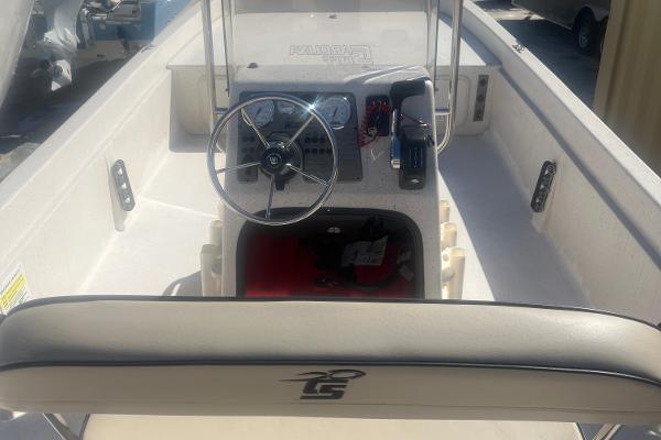 Slide: The Image of 2024 Carolina Skiff e24 DLX boat interior with steering wheel and control panel. - 4