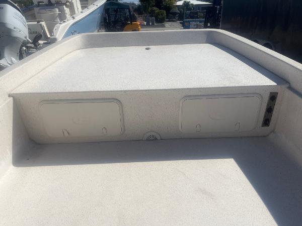 Slide: The Image of 2024 Carolina Skiff e24 DLX boat deck with storage compartments. - 6