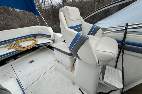 Slide: The Image of 1993 Carver 280 Express boat interior with white and blue seating. - 19