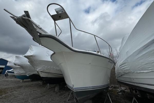 Slide: The Image of 1993 Carver 280 Express boat in storage yard, surrounded by other covered boats. - 8