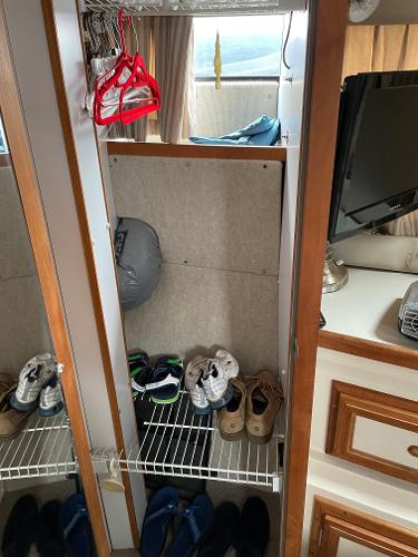 Slide: The Image of Closet interior of 1988 Carver 32 Mariner with shoes and hangers. - 13