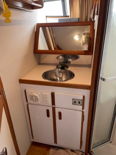 Slide: The Image of 1988 Carver 32 Mariner bathroom sink with mirror and storage cabinets. - 16