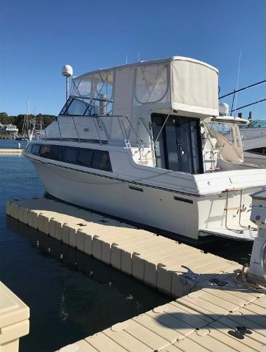 Slide: The Image of 1988 Carver 32 Mariner yacht docked at marina. - 3