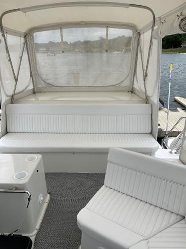 Slide: The Image of 1988 Carver 32 Mariner boat interior with white seating and lake view. - 4