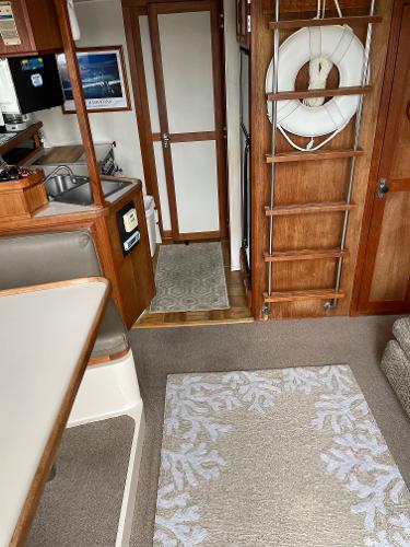 Slide: The Image of Interior of a 1988 Carver 32 Mariner boat with wooden finishes and a life preserver. - 6