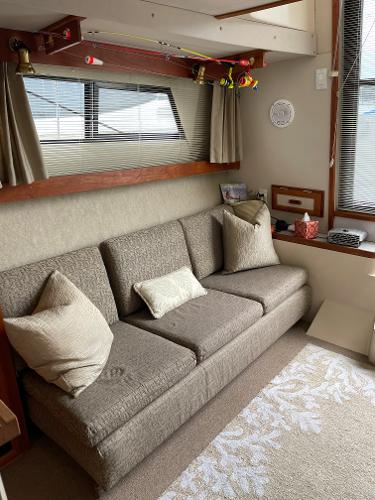 Slide: The Image of Interior of 1988 Carver 32 Mariner with beige sofa and decorative pillows. - 8