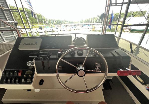 Slide: The Image of 1994 Carver 350 Aft Cabin helm with Garmin navigation system, docked at marina. - 10