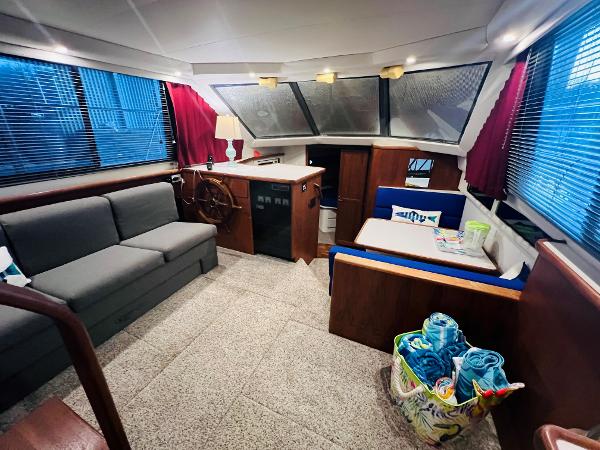 Slide: The Image of Interior of 1994 Carver 350 Aft Cabin with sofa, dining area, and helm station. - 21