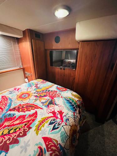 Slide: The Image of Cozy bedroom in 1994 Carver 350 Aft Cabin with vibrant floral bedding. - 33