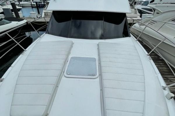 Slide: The Image of 2002 Carver 356 Motor Yacht docked, featuring spacious deck and sleek design. - 12