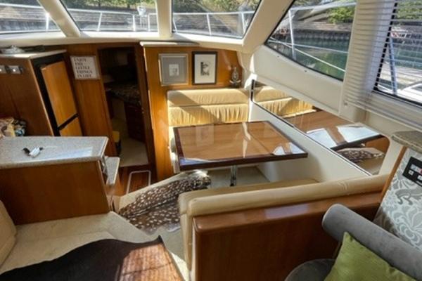 Slide: The Image of Interior of 2002 Carver 356 Motor Yacht with cozy seating and dining area. - 15