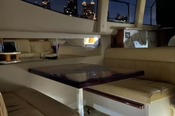 Slide: The Image of Interior of 2002 Carver 356 Motor Yacht with beige seating and wooden table. - 18