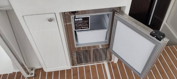 Slide: The Image of Open fridge on 2002 Carver 356 Motor Yacht, showcasing interior storage space. - 20