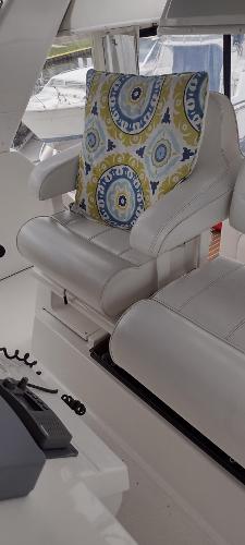 Slide: The Image of 2002 Carver 356 Motor Yacht interior with white seating and colorful cushion. - 22