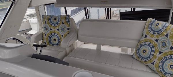 Slide: The Image of Interior of 2002 Carver 356 Motor Yacht with patterned cushions and white seating. - 25